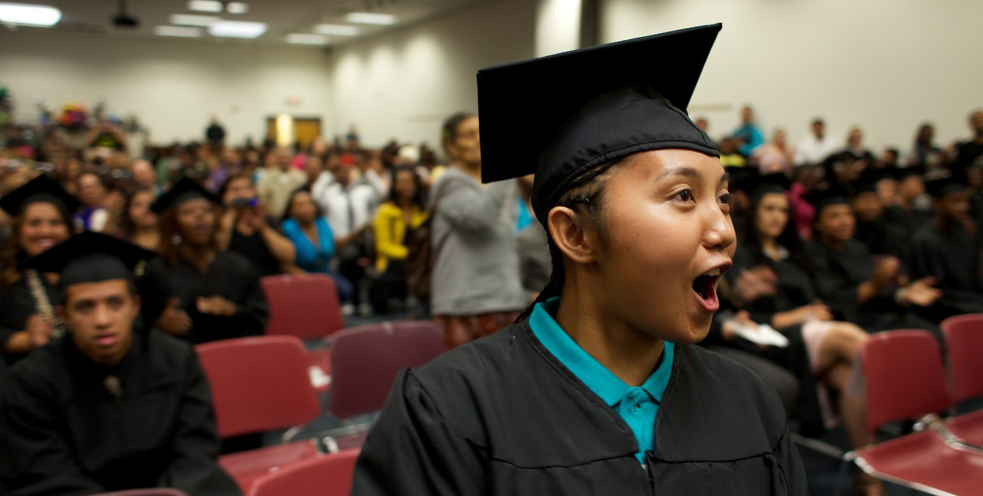 YouthBuild graduate in cap and gown
