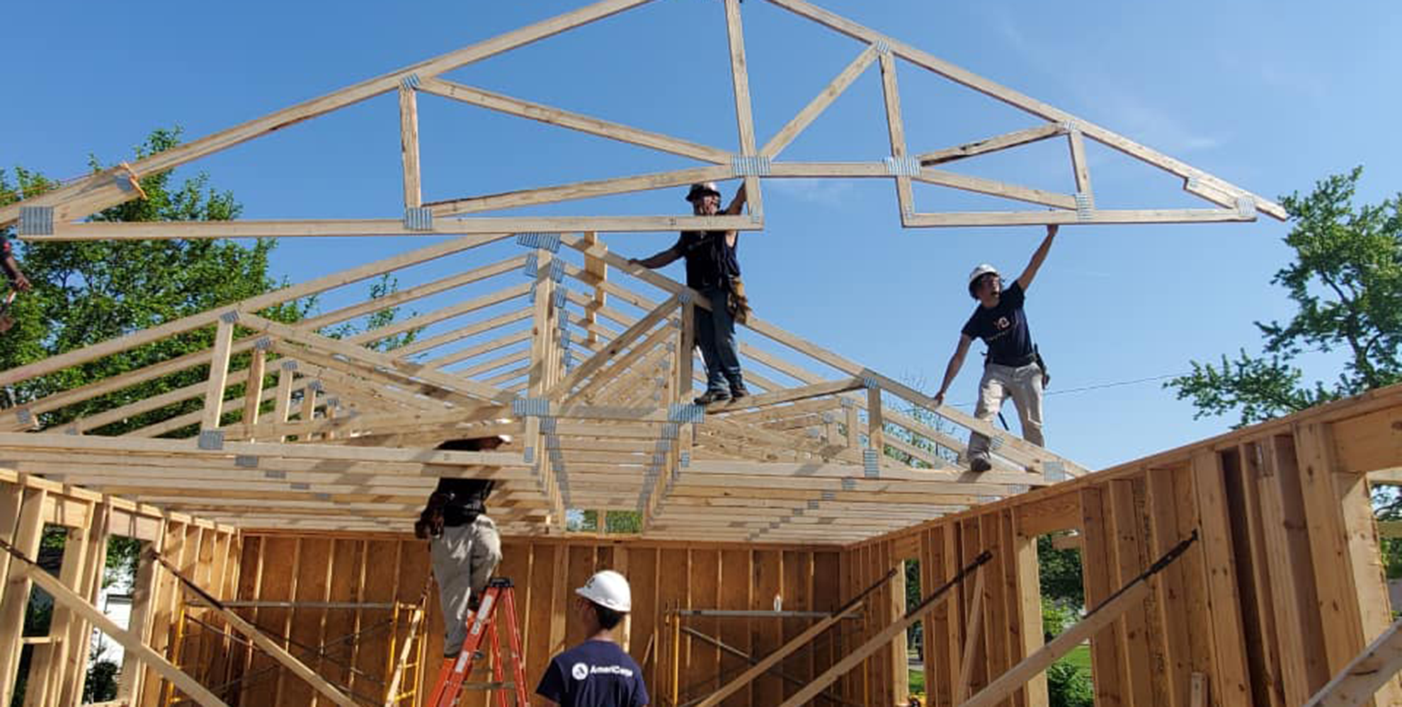 Students build the frame of a house.