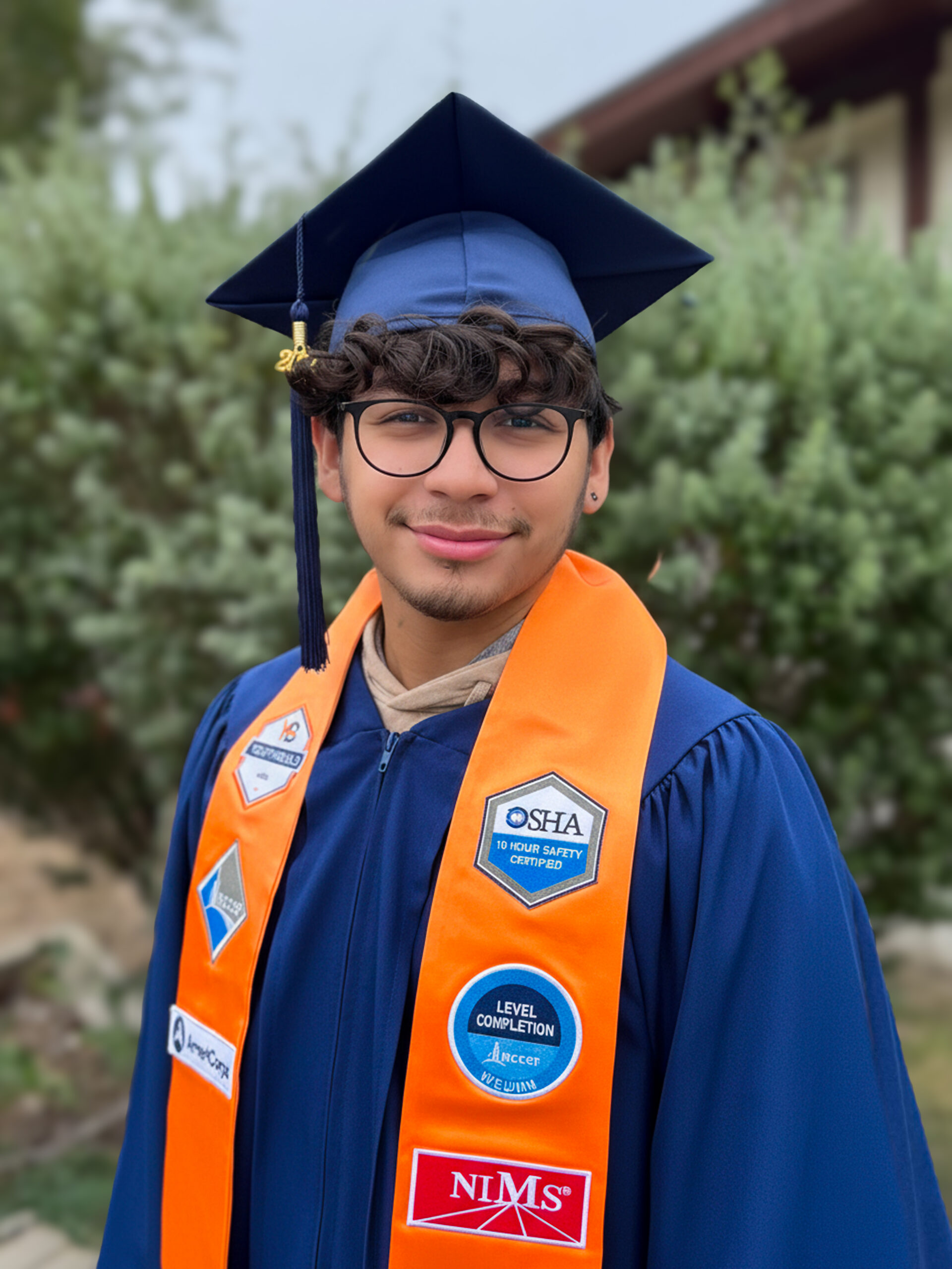 Portrait of Rolando Mendoza in graduation cap and gown